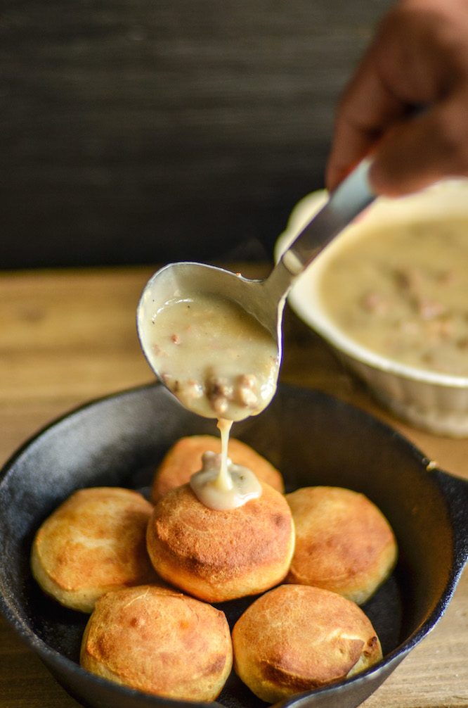 Ladeling finished gravy over biscuits | RedheadBabyMama.com