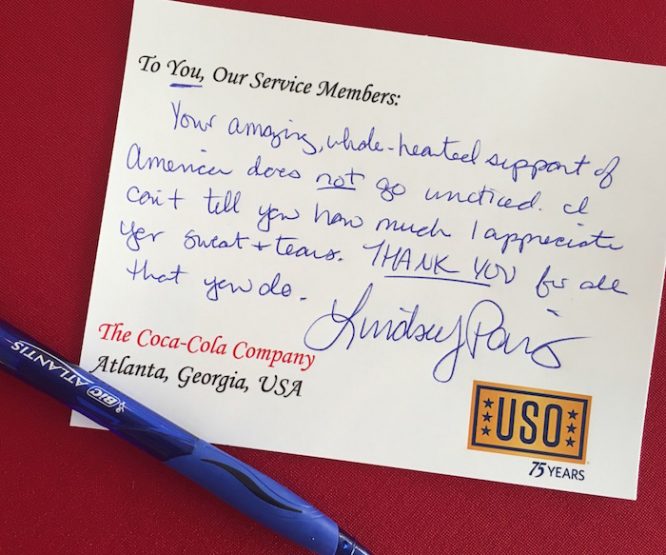A #VeteransDay USO Care package note is set to accompany a care package at Cola Cola HQ